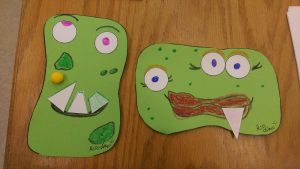 Photo of two completed monster face crafts.